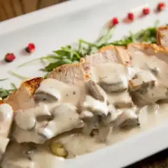 Kawałki kurczaka w kremowym sosie pieczarkowym, idealne do nauki jak zrobić sos pieczarkowy.