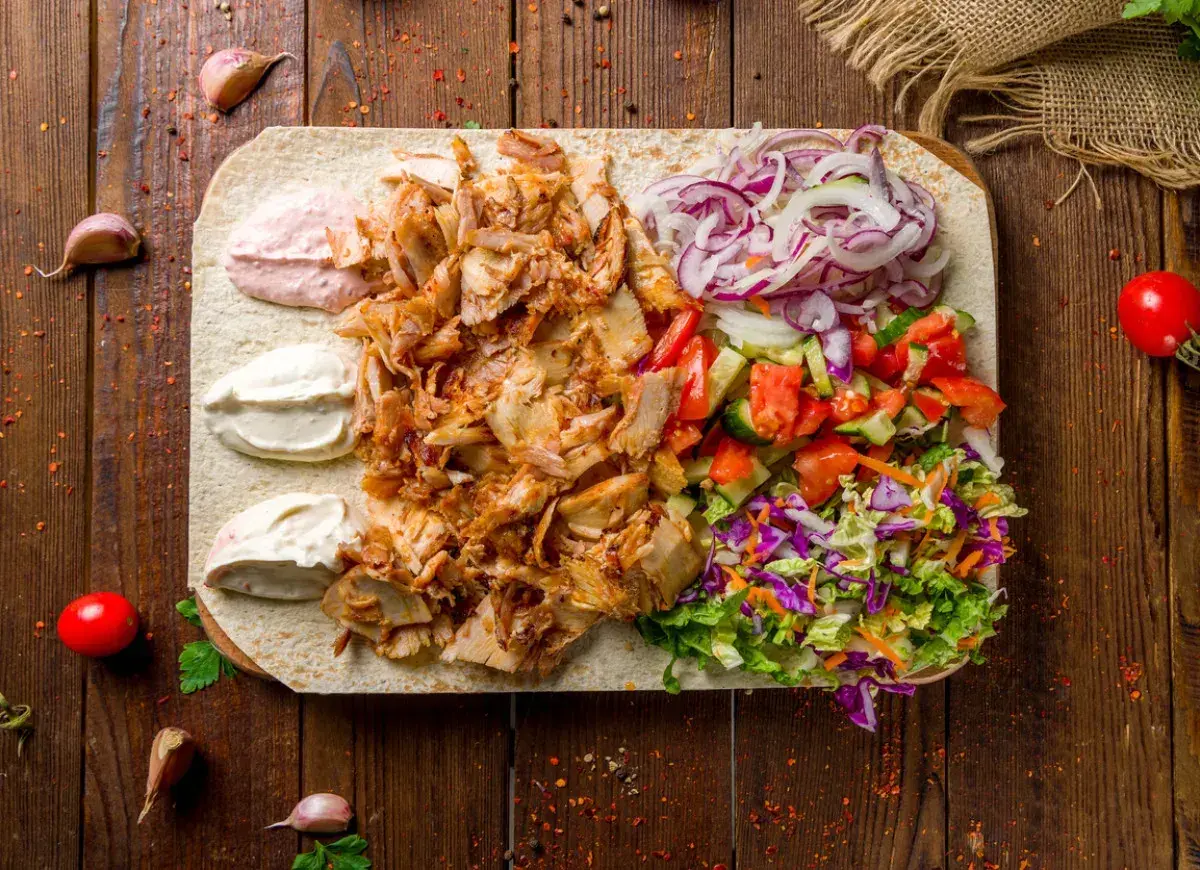 Pyszna shoarma z kurczaka na placku z warzywami i sosami. Idealna na szybki posiłek.